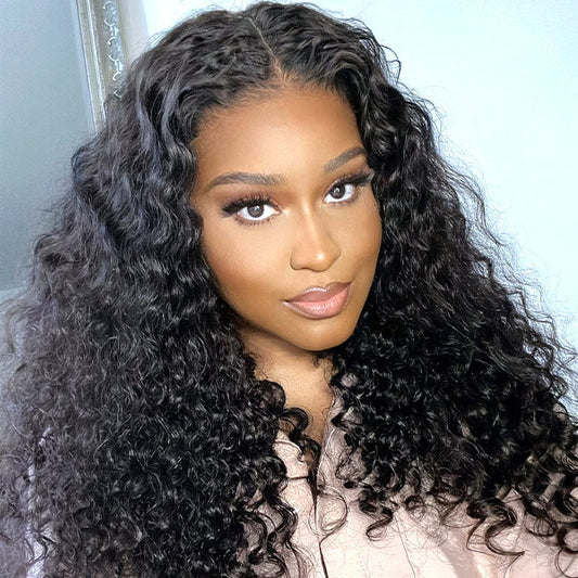 A woman models a NuHaire Easy to Install Loose Deep Wave Human Hair wig with 180% density, showcasing its full volume from root to tip, the seamless 6x4 HD glueless lace closure, and the premium wavy texture of the hair.