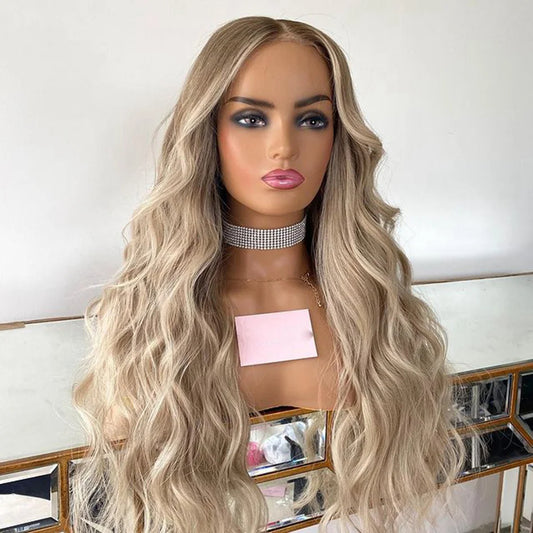 Different angle of Mannequin displaying 4/613 light blonde ombre 13x6 transparent lace front wig displaying loose beach wave texture, natural hairline, and full length European virgin hair with neutral background