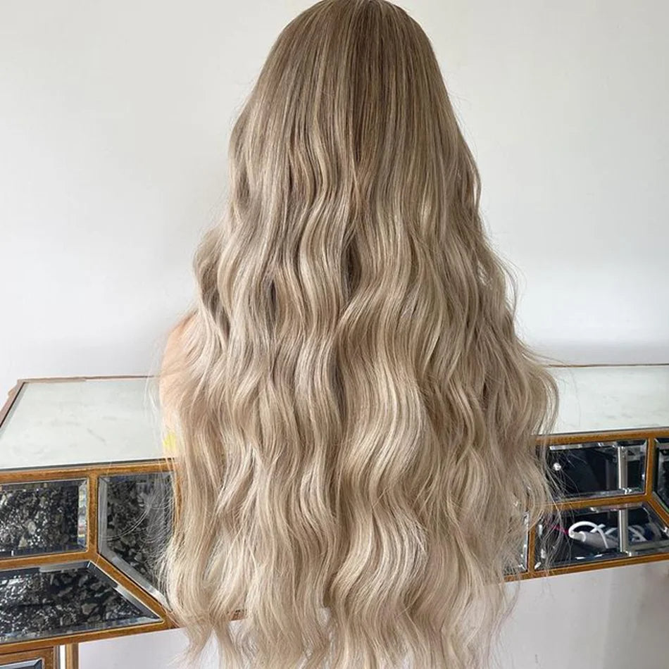 Back view of Mannequin displaying 4/613 light blonde ombre 13x6 transparent lace front wig displaying loose beach wave texture, natural hairline, and full length European virgin hair with neutral background
