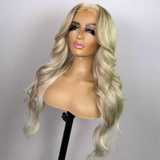 View of ash honey brown highlight wig displaying loose wave texture and natural movement
