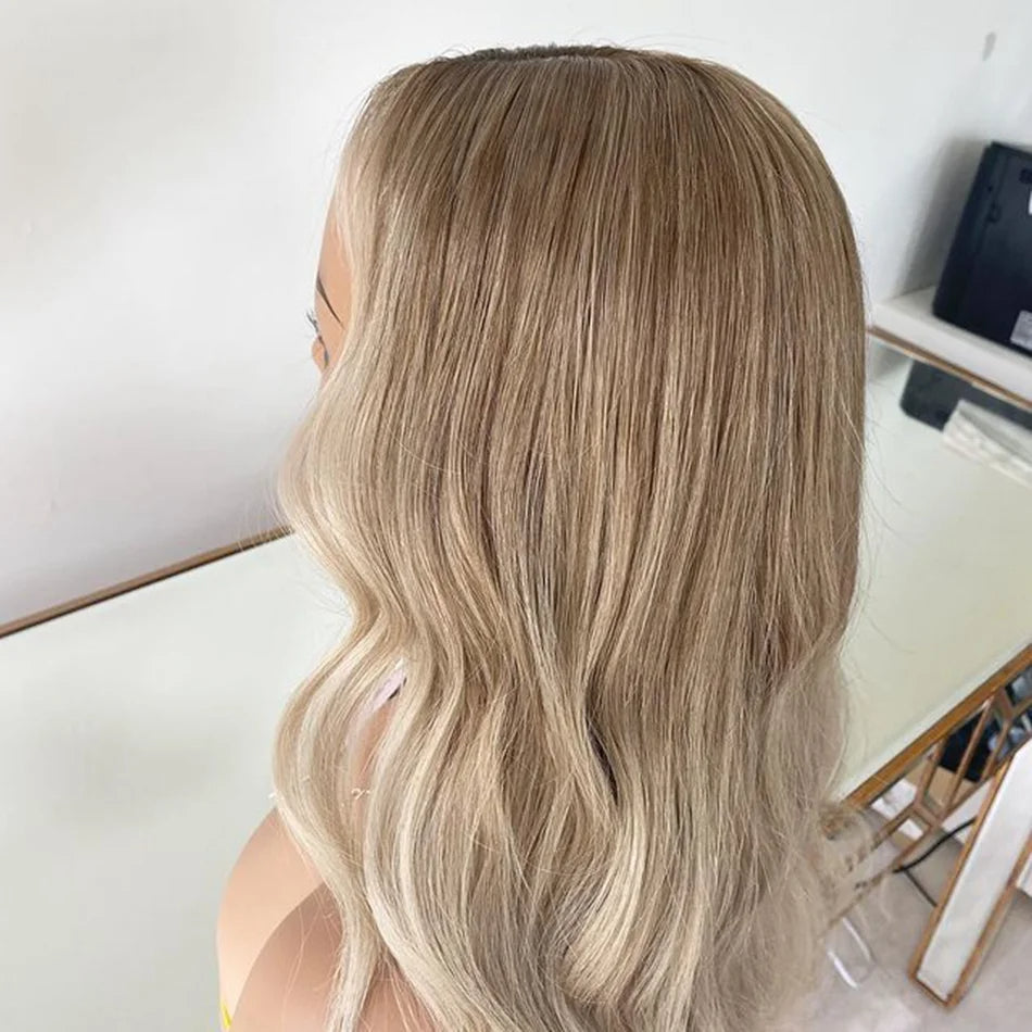 Up close angle of Mannequin displaying 4/613 light blonde ombre 13x6 transparent lace front wig displaying ombre color, highlights, loose beach wave texture, natural hairline, and full length European virgin hair with neutral background