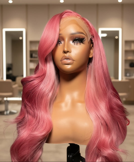 Side view of Mannequin head with NuHaire Raspberry pink balayage wig, showcasing pink body waves, premium European Human Hair Quality, 13x4 transparent lace front, and natural hairline in a room setting.