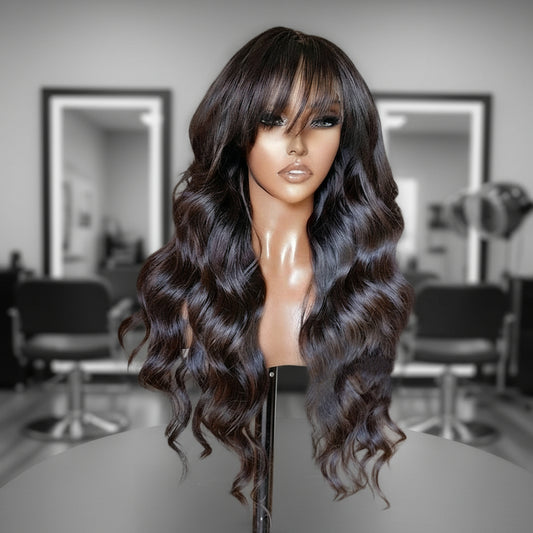 Mannequin head displays NuHaire's Ready to Wear Loose Wave Wig with Bangs, featuring a natural black color, flowing loose wave texture, glueless install with bangs, and premium human hair.