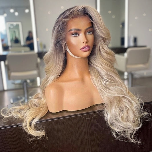 A mannequin in a salon setting displays NuHaire's Ombre Ash Blonde Highlight wig, featuring a dark root that transitions to ash blonde. This high-quality human hair wig offers 200% density and includes a 13x6 lace front with transparent lace for a natural hairline.