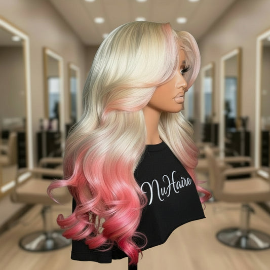Front view of Mannequin head featuring NuHaire's 5x5 pink peekaboo highlights on a 613 blonde body wave human hair wig, showcasing a flawless color transformation, premium human hair quality, lace closure hairline, and bouncy body waves against a neutral background.