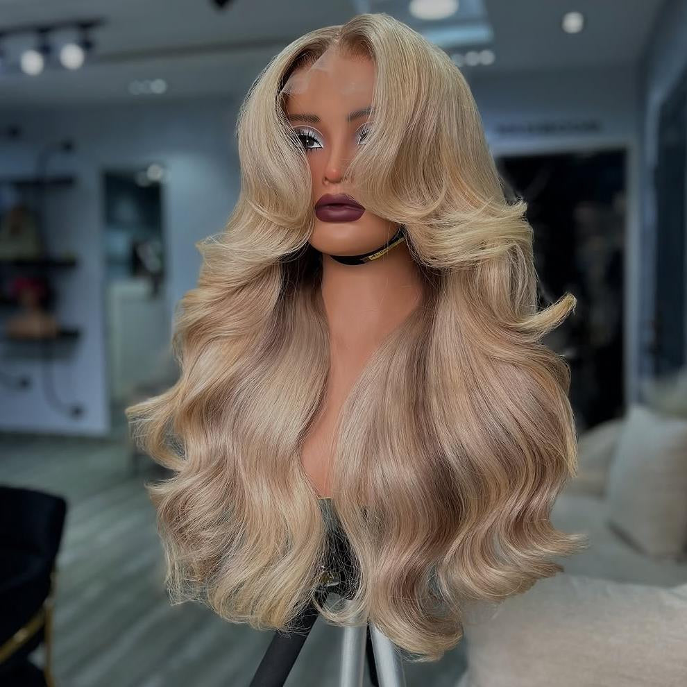 Different view of A mannequin showcases NuHaire's Ash Blonde Ombre Layered Cut Loose Wave Wig, featuring a brown root that blends into ash blonde highlights. This 250% density human hair wig offers a layered cut, loose wave texture, and various transparent lace size options for a natural hairline.