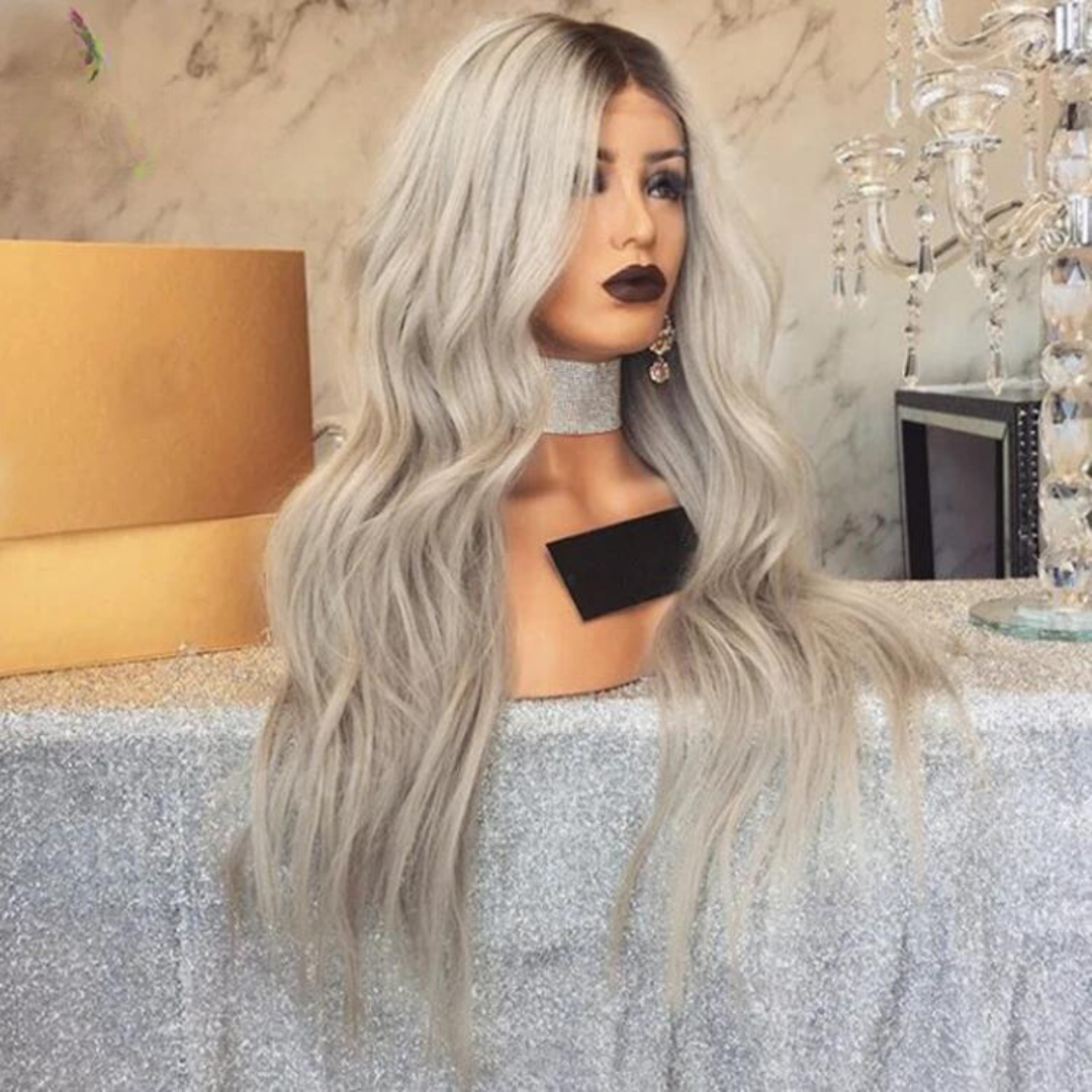 A side image display of a mannequin head showing a NuHaire 13x6 transparent lace front human hair wig, highlighting the ombre ash blonde color technique, premium European human hair, and beach wave texture.