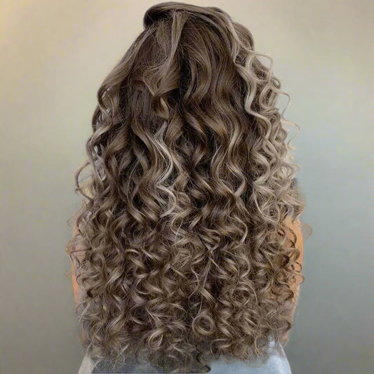 Back view of icy blonde highlight curly European wig displaying full hair density and natural curl pattern
