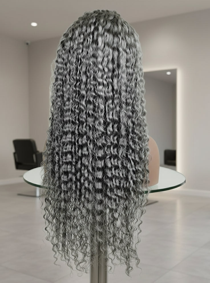 Back view of a mannequin head showcasing NuHaire's Silver Grey Deep Curly Transparent Lace Front Human Hair Wig, featuring a natural silver grey hair color, premium quality human hair, a bouncy deep curly texture, and a 13x6 transparent lace front.