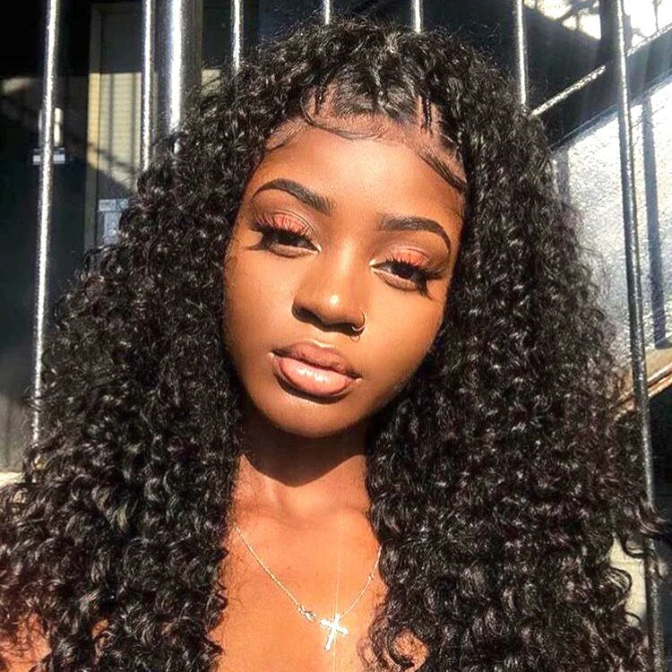 A model showcases NuHaire's 13x4 voluminous Peruvian curly human hair wig, styled with bouncy, defined curls that frame her face beautifully. She poses confidently against a bright, neutral backdrop, highlighting the wig's texture and dramatic flair.