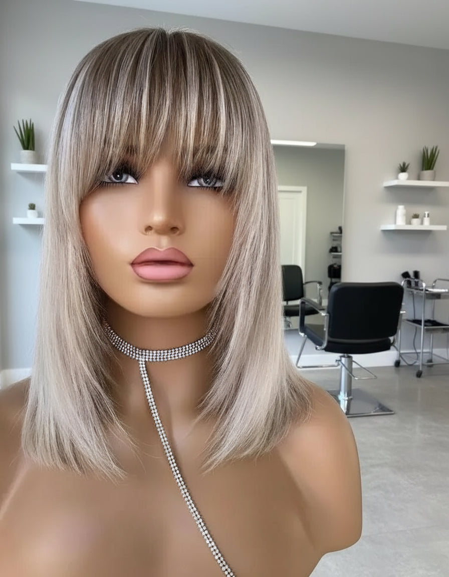 A mannequin displays NuHaire's Short Straight Ash Blonde Highlight Human Hair Bob Wig with Bangs, featuring ash blonde highlights, high-quality European Human Hair, full volume, and beginner friendly installation.