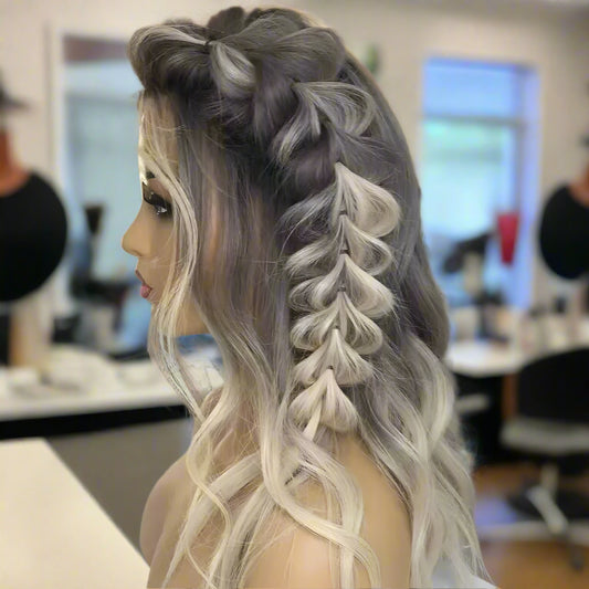 A side view of a mannequin head showcasing NuHaire's 13x4 transparent lace front Root Melt Ash Blonde Balayage Natural Wave human hair wig, highlighting the styling versatility, luxurious root melt balayage coloring, premium European human hair, and natural wave texture.