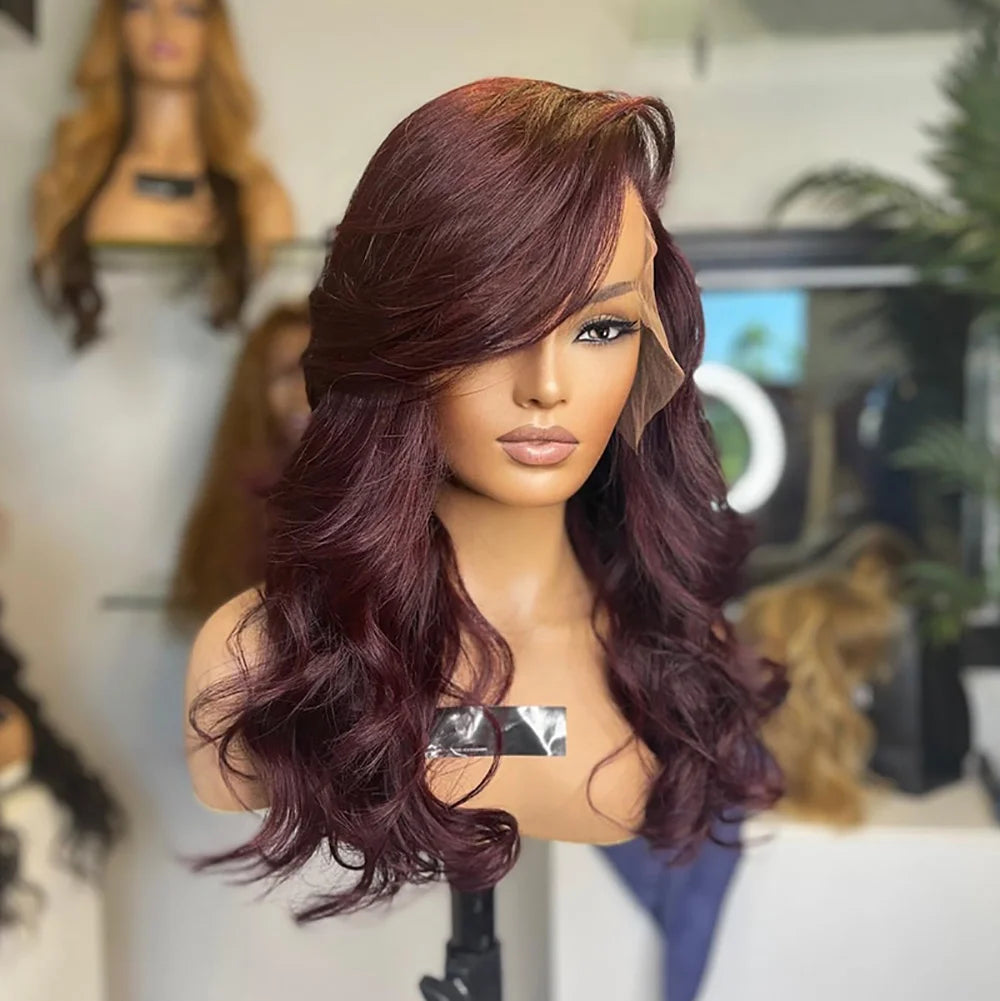 Deep Burgundy 13x6 Transparent lace front human hair natural wave wig displayed on a mannequin head showing a premium natural hairline, natural wave texture, and a realistic scalp in a hair salon