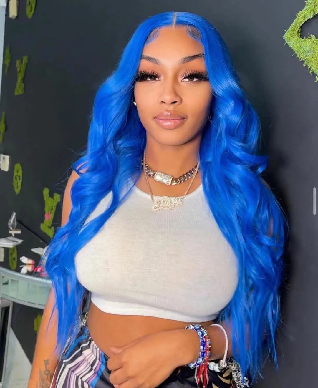A person wearing a NuHaire sky blue human hair wig with a 13x4 transparent lace front, pre-plucked hairline, styling versatility, and natural hairline