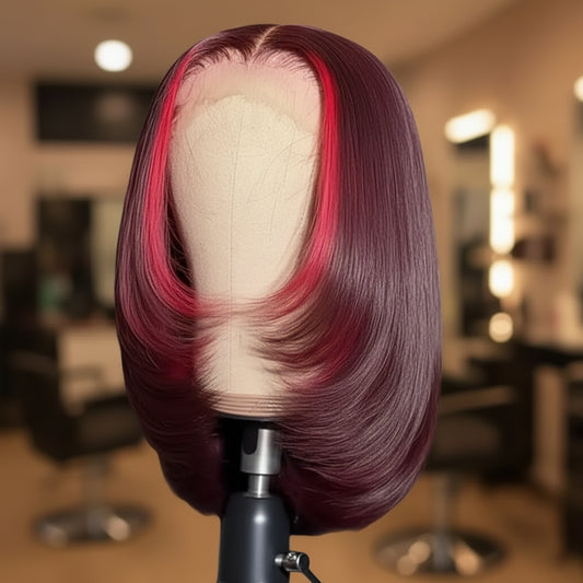 13x4 Transparent lace front highlight human hair straight bob wig displayed on mannequin head showing chunky red highlight, rich 99J burgundy color, straight texture, premium natural hairline, styling versatility, and realistic scalp with hand stroking hair in a hair salon