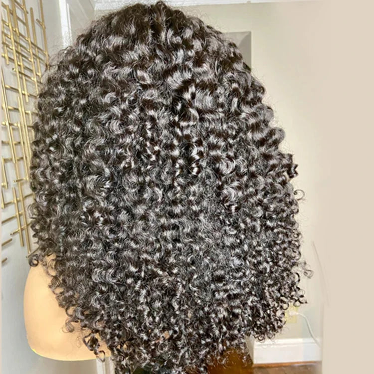 A back view of NuHaire's short pineapple curly bob hairstyle, showcasing defined curls that create a voluminous and playful look. The hair is evenly cut at the nape of the neck, with the curls bouncing freely, highlighting the natural texture and shape.