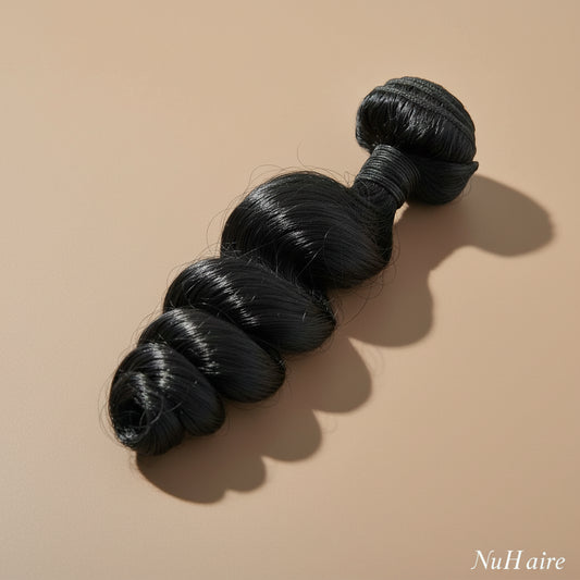 NuHaire's Loose Wave | 1 Piece Human Hair Bundle features a natural black color and premium human hair quality. It is available in Brazilian and Indian hair textures, providing full volume from root to tip with natural waves.