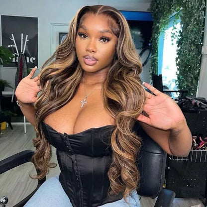 Model sitting in hair salon chair showcasing 4/27 honey blonde highlight 13x4 transparent lace front wig with full body wave texture displaying long body wave length