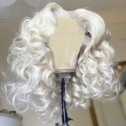 Platinum blonde loose curly wig front view on mannequin showing 13x4 lace and luminous color