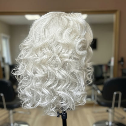 Side view of platinum blonde curly wig on a mannequin head with a blurred salon background