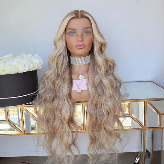 Mannequin displaying 4/613 light blonde ombre highlight 13x6 transparent lace front wig displaying loose beach wave texture, natural hairline, and full length European virgin hair with decorative background