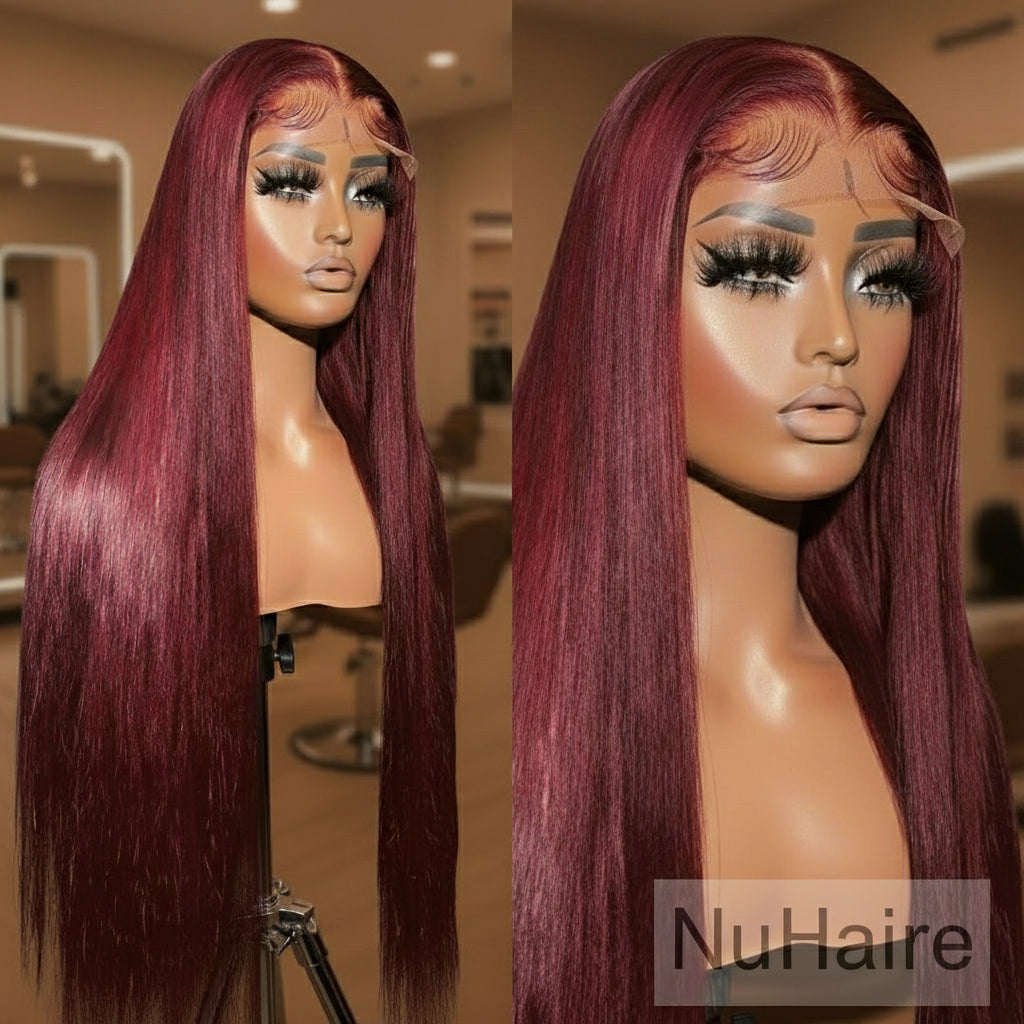 Two mannequin heads with burgundy wigs in a salon setting.