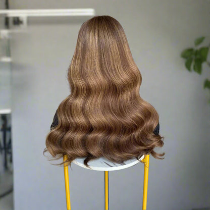 Back view of long, European human hair, featuring an Espresso Brown Balyage loose wavy brown 9x5 glueless mono lace wig, set on a chair indoors.