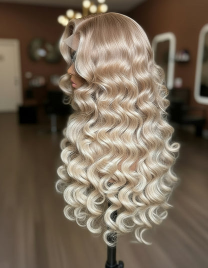Blonde wig with wavy hair on a mannequin head in a blurred indoor setting