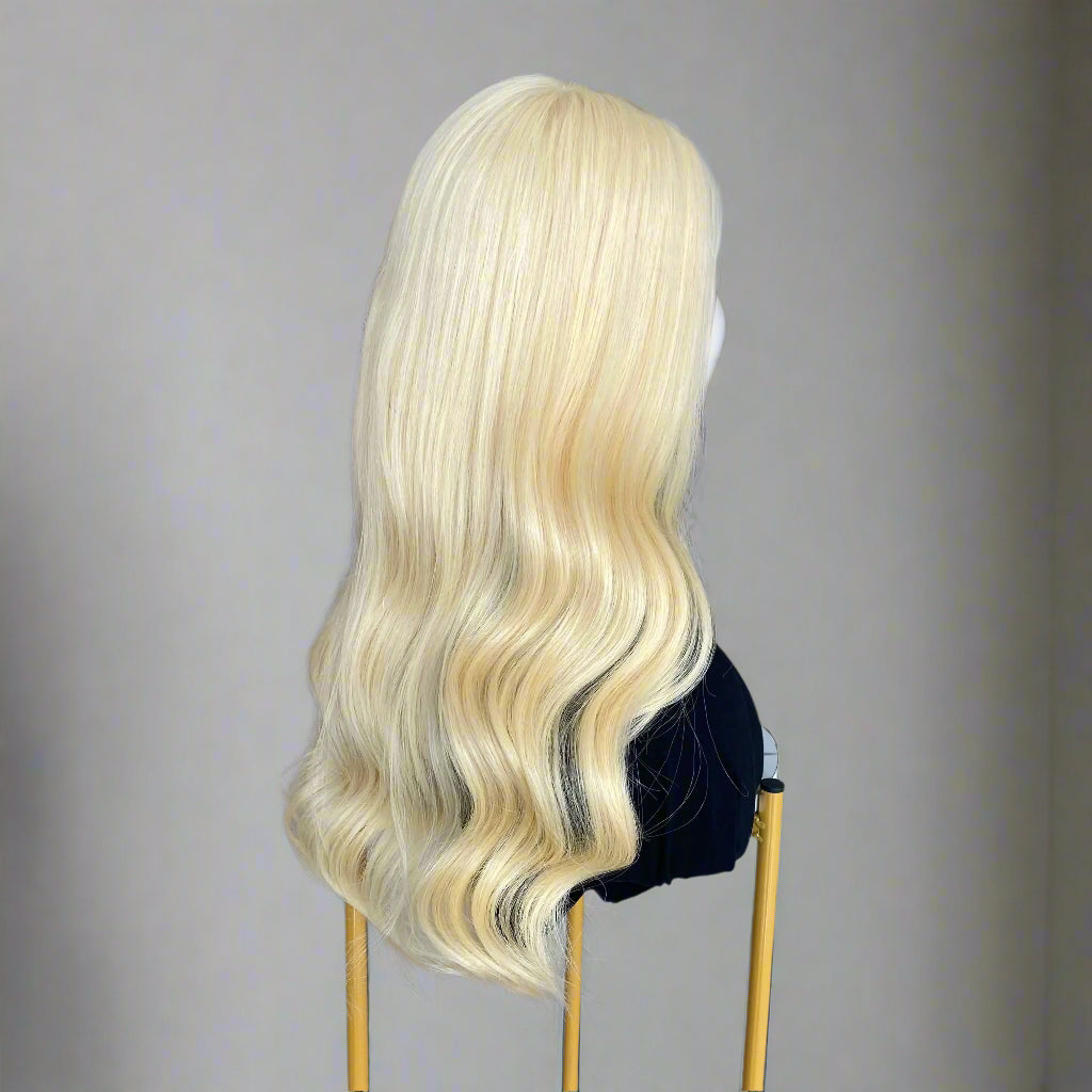 Side view of 613 light Blonde Glueless European human hair body wave wig on a mannequin head in a hair product display area.