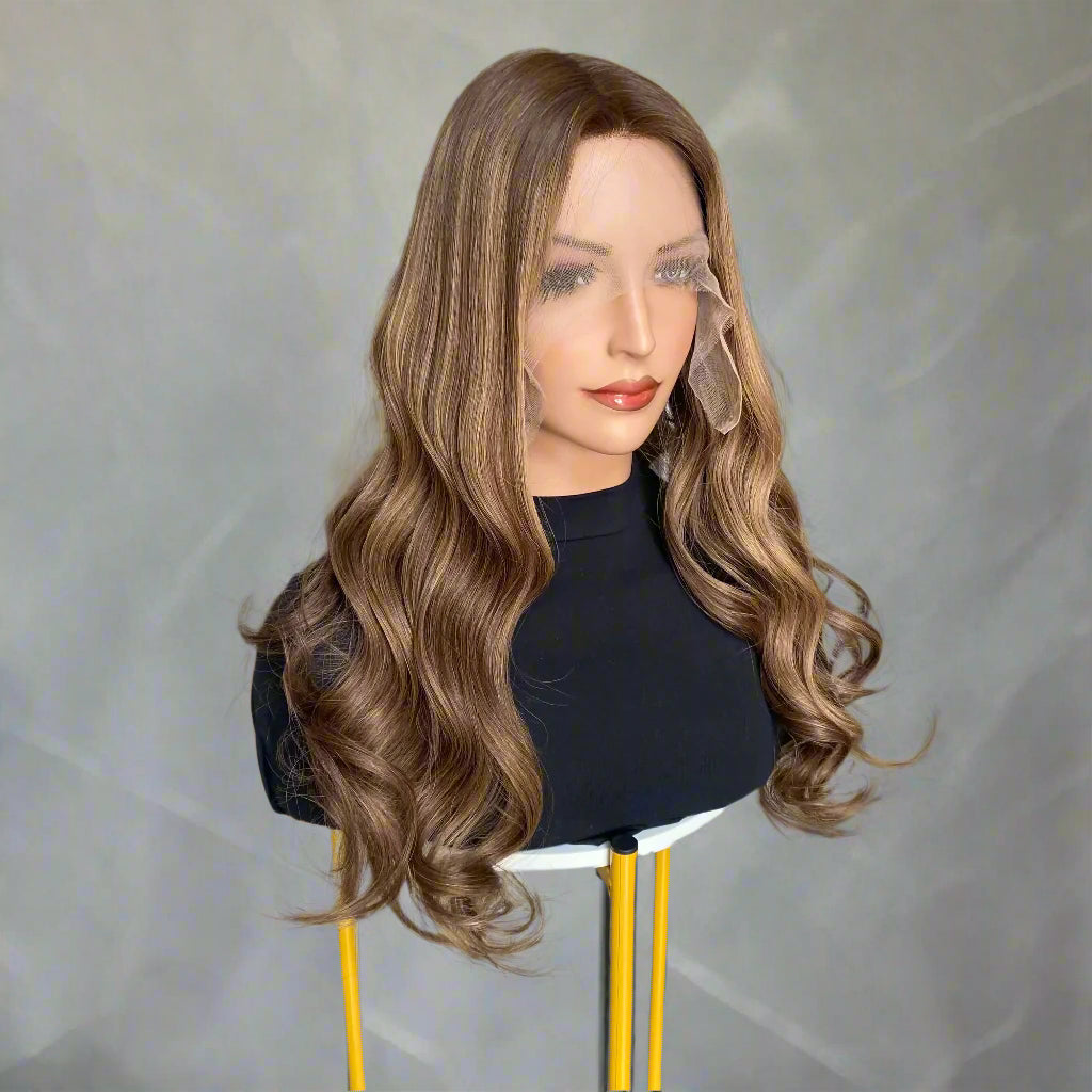 Mannequin head with long, European human hair, featuring an Espresso Brown Balyage loose wave 9x5 glueless mono lace wig, set on a chair inside a hair salon