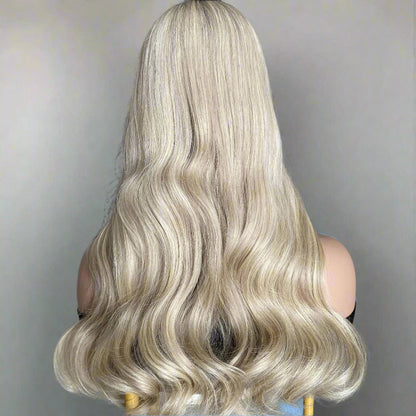 Back view of 18/60 pearl ash blonde natural wave wig displaying full hair density and natural movement