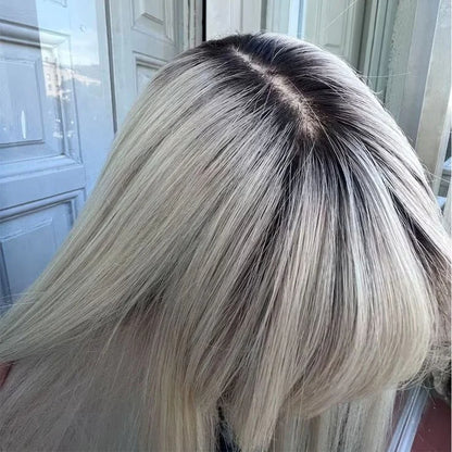 Close-up of ash blonde highlight wig showing realistic scalp appearance and dark root color blend"