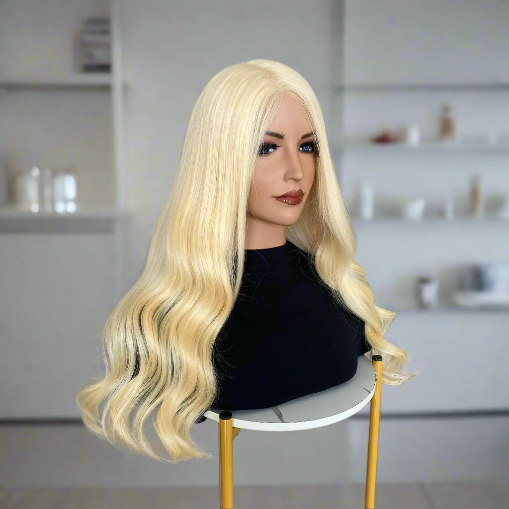 Mannequin head with long European human hair, light 613 blonde body wave wig in a hair salon setting