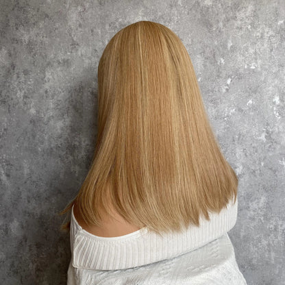Back view of duo tone ash brown mono lace wig displaying full hair density and dimensional depth