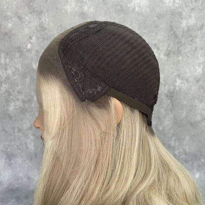 Side view of pearl ash blonde wig cap construction showing transparent lace construction and ultra-realistic scalp
