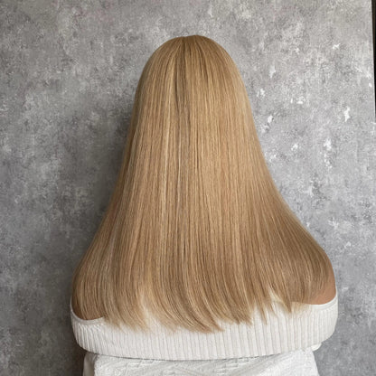 Back angle view of duo tone ash brown wig showcasing natural drape and hand-tied construction