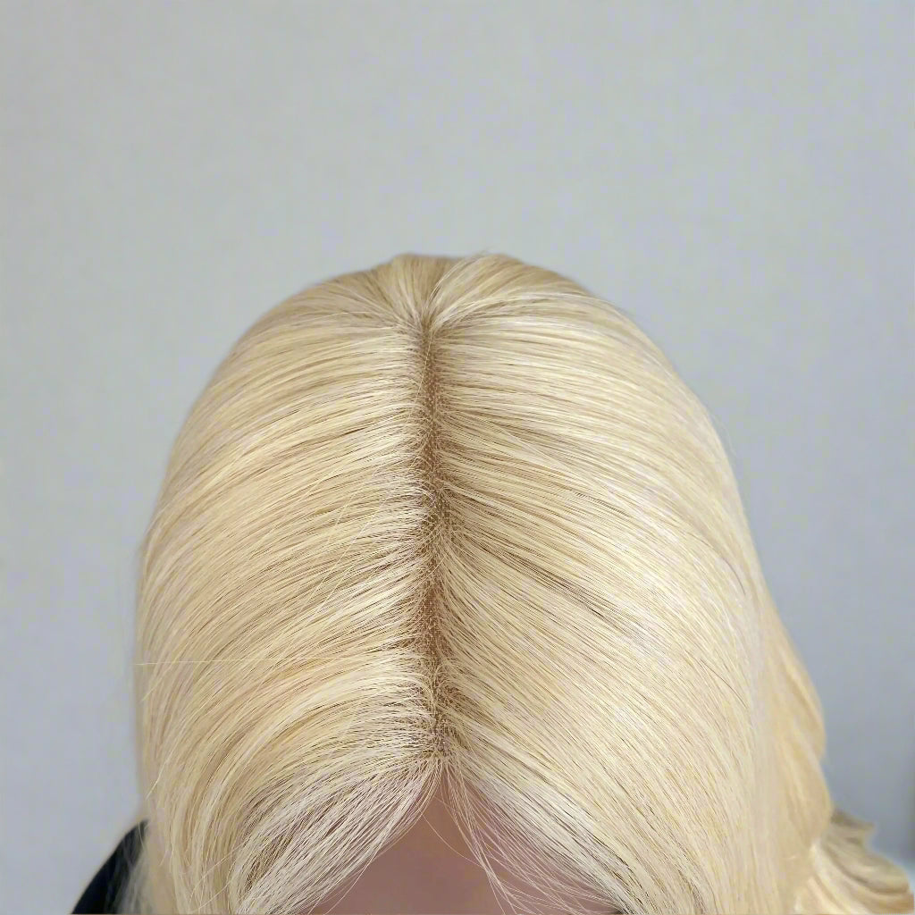Up close imange of realistic scalp of European human hair light blonde 613 body wave wig, glueless 9x5 lace