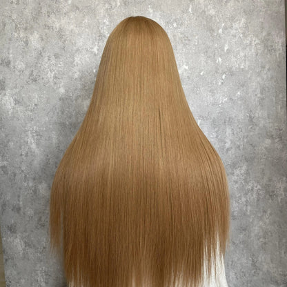 Back view of strawberry blonde straight wig displaying full hair density and natural drape