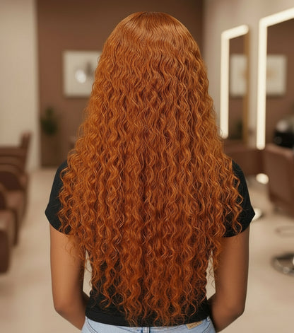 The back view of the model wearing the NuHaireCurly Ginger (350) Transparent Lace Front Human Hair Wig showcases bouncy curls, a flawless ginger-orange color, premium human hair quality, a 13x4 transparent lace front, and a natural hairline.
