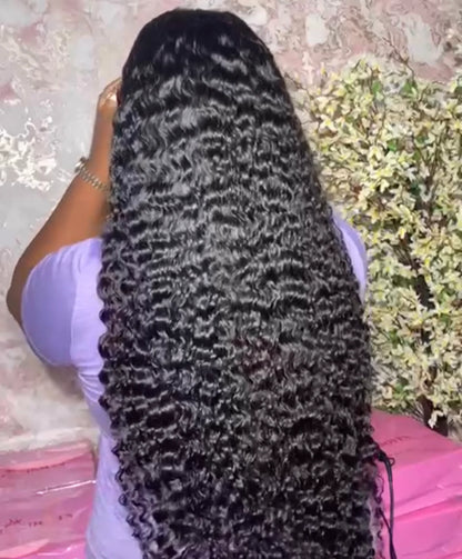 Back view og 13x4 Natural Curly HD Lace Front Wig on woman displaying premium Burmese human hair, realistic scalp and lace construction in a NuHaire hair salon