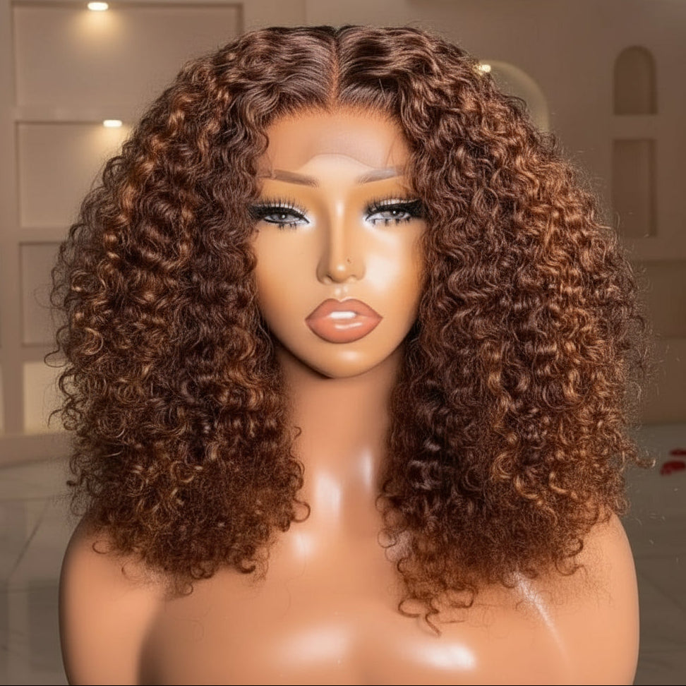 Front view of A mannequin head displaying the NuHaire Auburn Ombre Pixie Curly Human Hair Wig, which features a rich auburn ombre color, premium quality human hair, a 5x5 transparent lace closure, a natural hairline, and bouncy pixie curly texture.