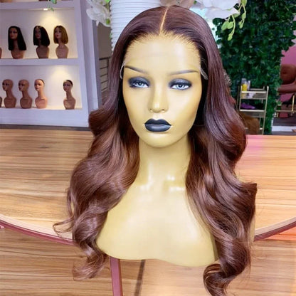 13x4 Transparent lace front auburn highlight human hair body wave wig displayed on mannequin head showing premium natural hairline, styling versatility, and realistic scalp in NuHaire hair salon