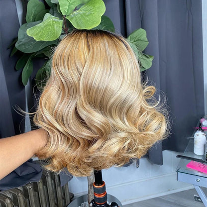 Back view of 1B/613 blonde ombre bob 13x4 transparent lace wig with body wave texture on mannequin head displaying full bob length and ombre color blend