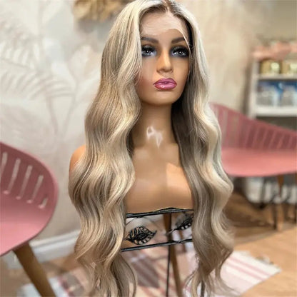 A wig with a pre-plucked hairline, featuring light ash blonde body wave transparent lace front, presented on a mannequin with a pink background.