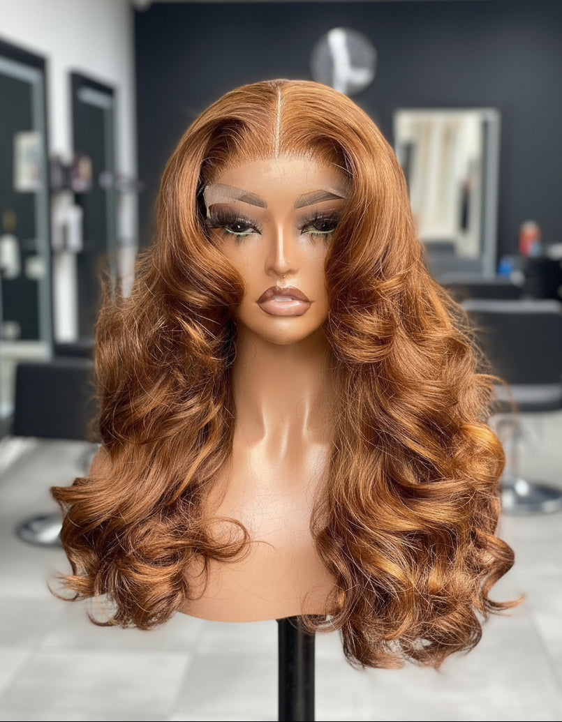 Different Angle of A NuHaire Human Hair wig with a 13x4 transparent lace front featuring a flowing natural wavy texture and ginger brown ombre color, displayed on a mannequin head.