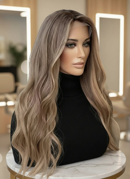 Side view of Mannequin head with NuHaire Golden Blonde Balayage Highlight Wig, showcasing dark blonde waves, flawless golden blonde balayage highlight, premium European Human Hair Quality, 13x4 transparent lace front, and natural hairline.