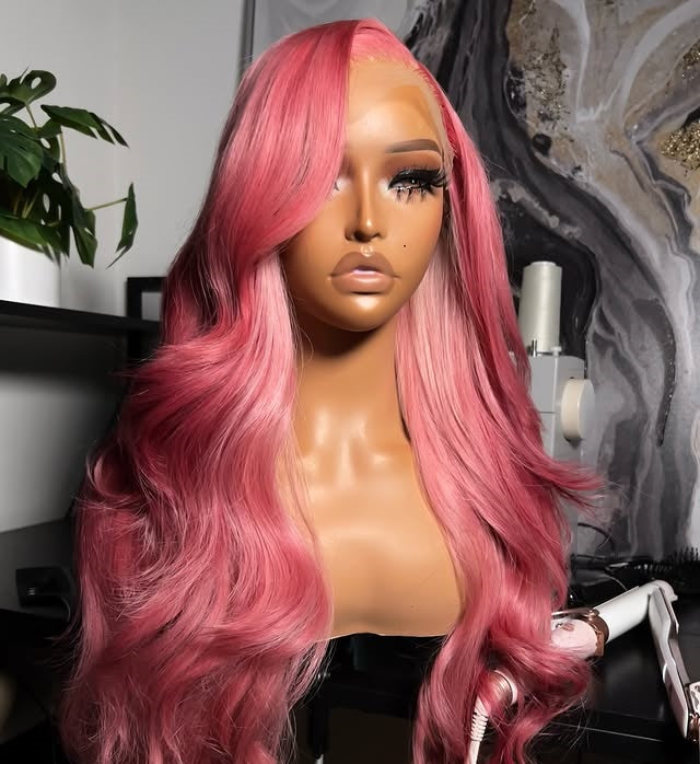 Front view of Mannequin head with NuHaire Raspberry pink balayage wig, showcasing pink body waves, premium European Human Hair Quality, 13x4 transparent lace front, and natural hairline in a room setting.