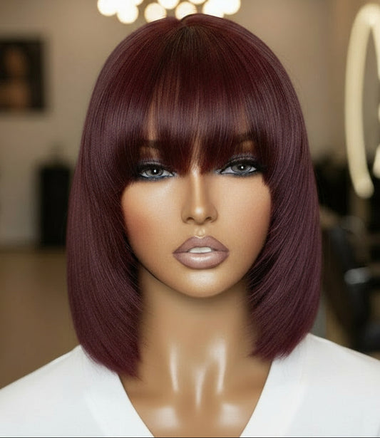 Different view of A mannequin head displaying NuHaire's Burgundy Straight Bob with Bangs, showcasing a flawless Burgundy 99j hair color, premium human hair quality, glueless installation, and silky straight texture.