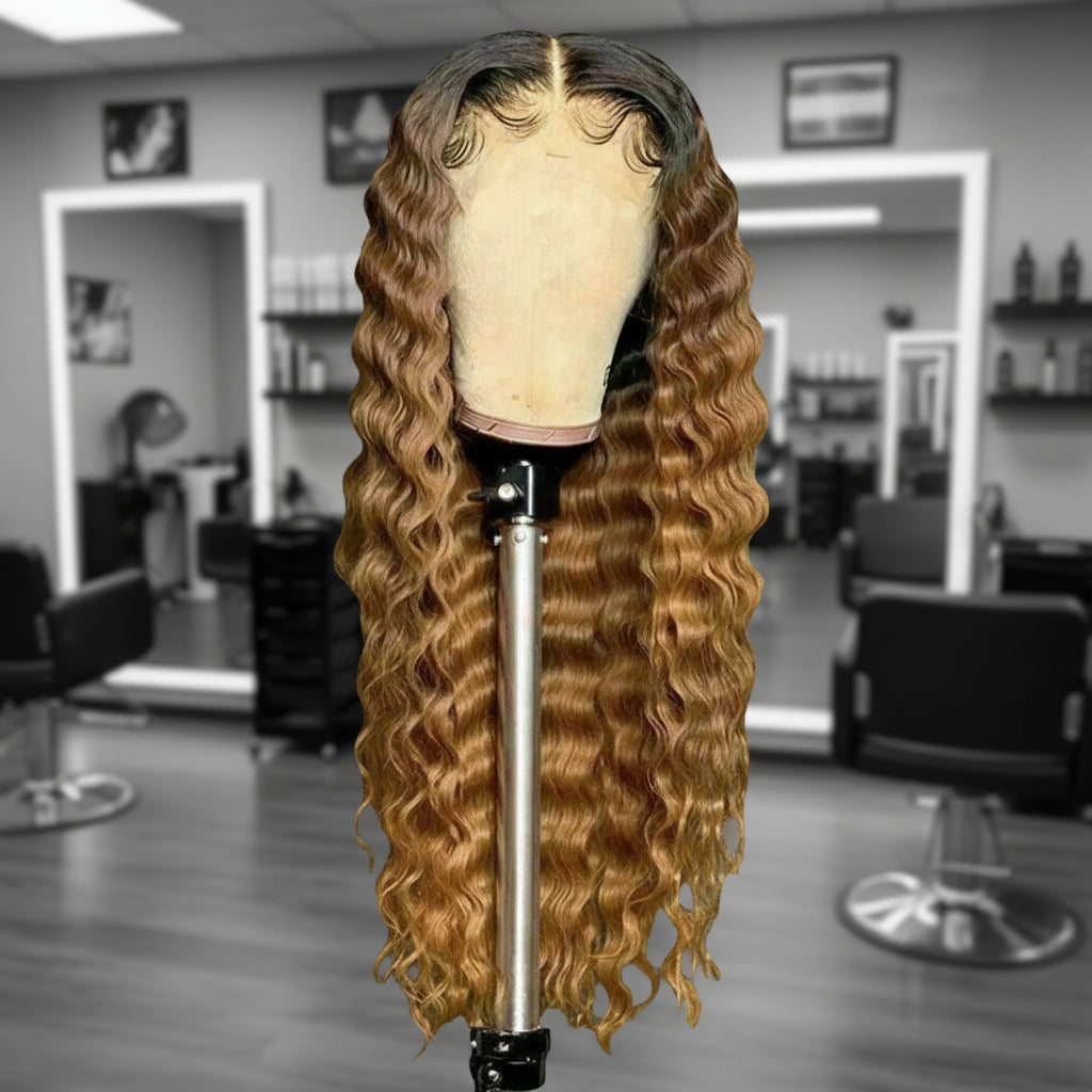 Front view of Mannequin head featuring a NuHaire Honey Blonde Ombre Deep Curly Human Hair Wig, showcasing rich honey blonde ombre, styling versatility, flowing deep curly wave texture, and skin melt thin 13x6 HD transparent lace.