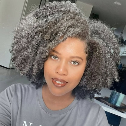 Closer view of a Model showcasing NuHaire's Salt & Pepper Kinky Curly Bob | 13x4x1 Transparent Lace Human Hair Wig, featuring a natural black and silver grey hair color, premium human hair, bouncy kinky curly texture, and a 13x4 Transparent Lace Front.